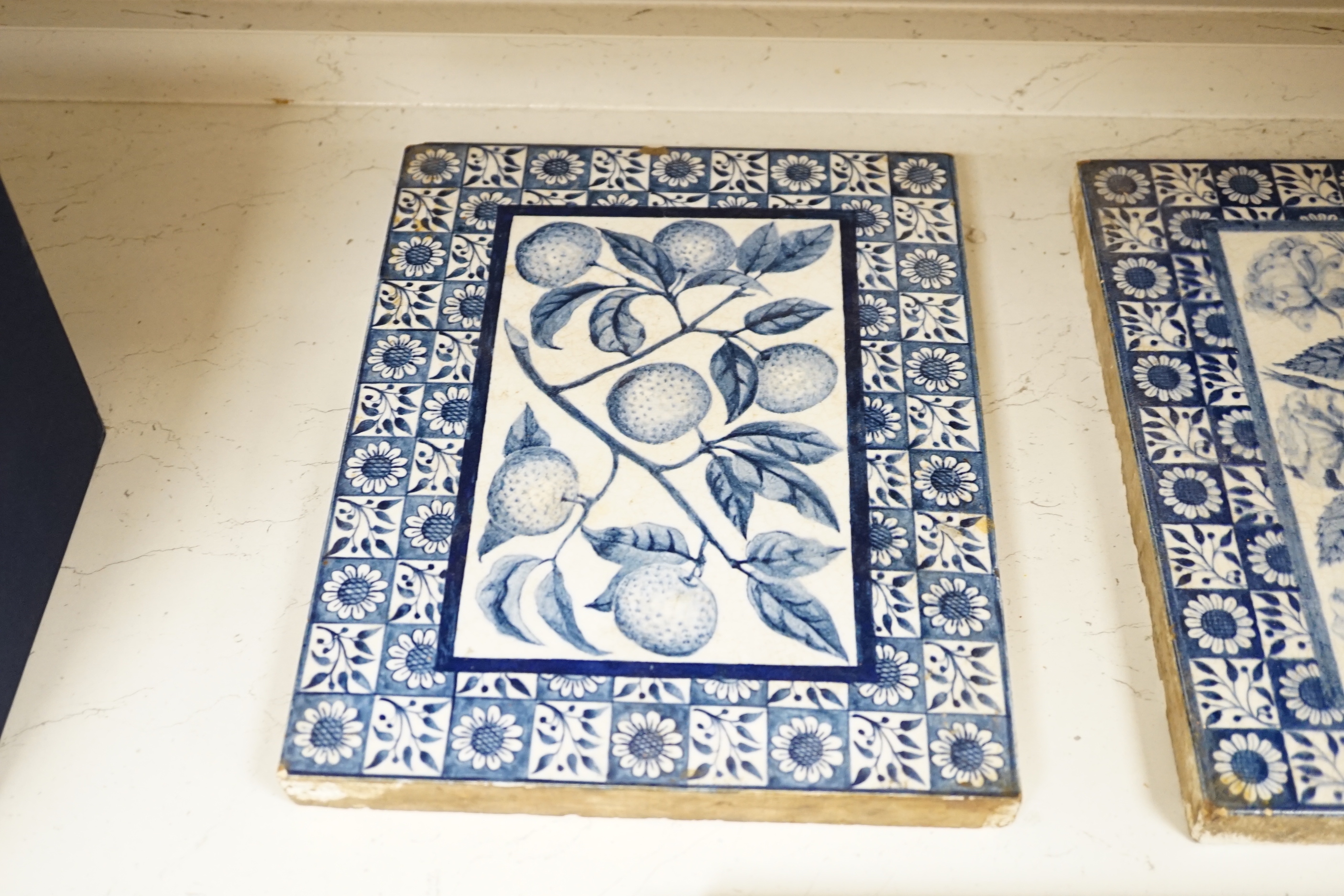 Three Victorian blue and white Mintons tiles decorated with flowers and fruit, each stamped to the base, each 29cm x 22cm